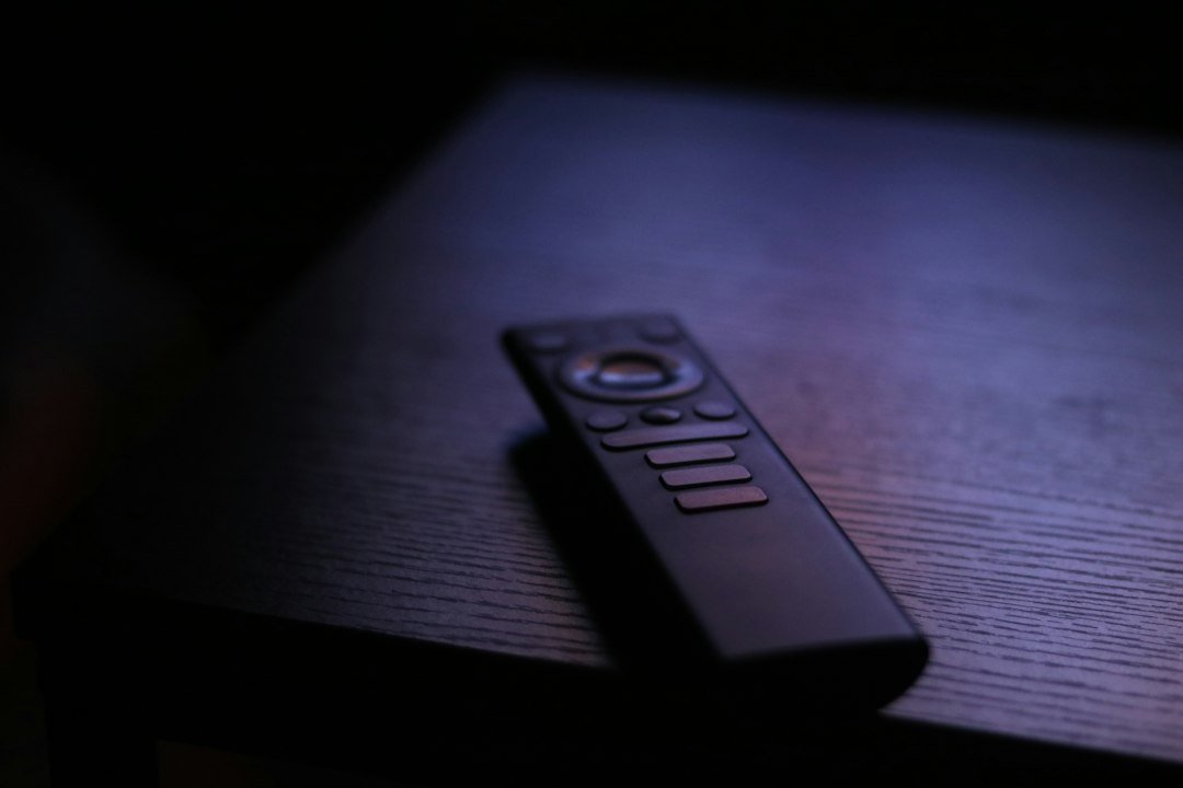 Television remote resting on a table