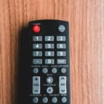 black remote control on brown wooden table