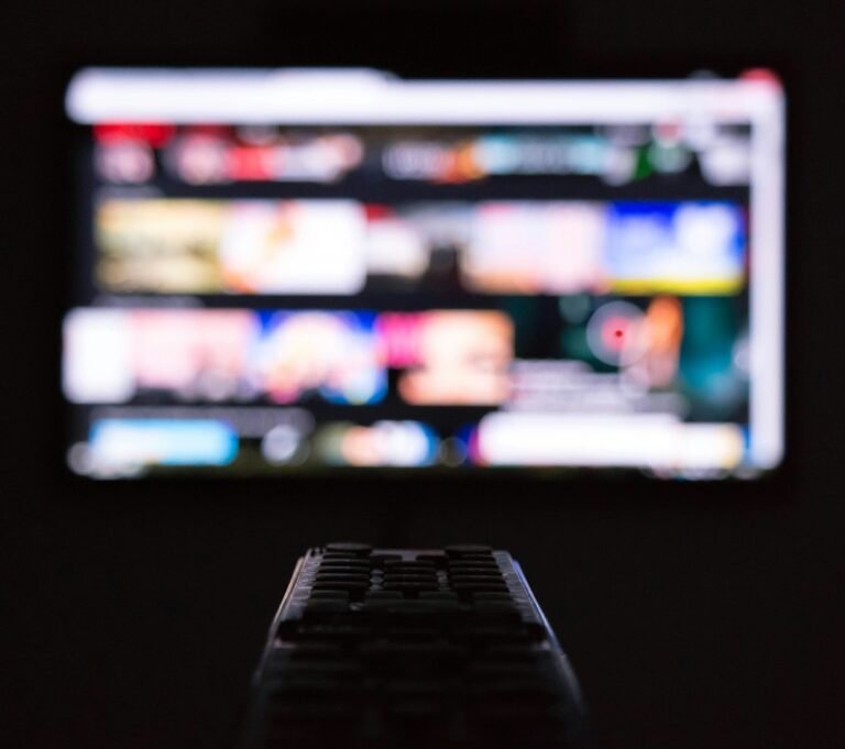 Remote control held in front of a television