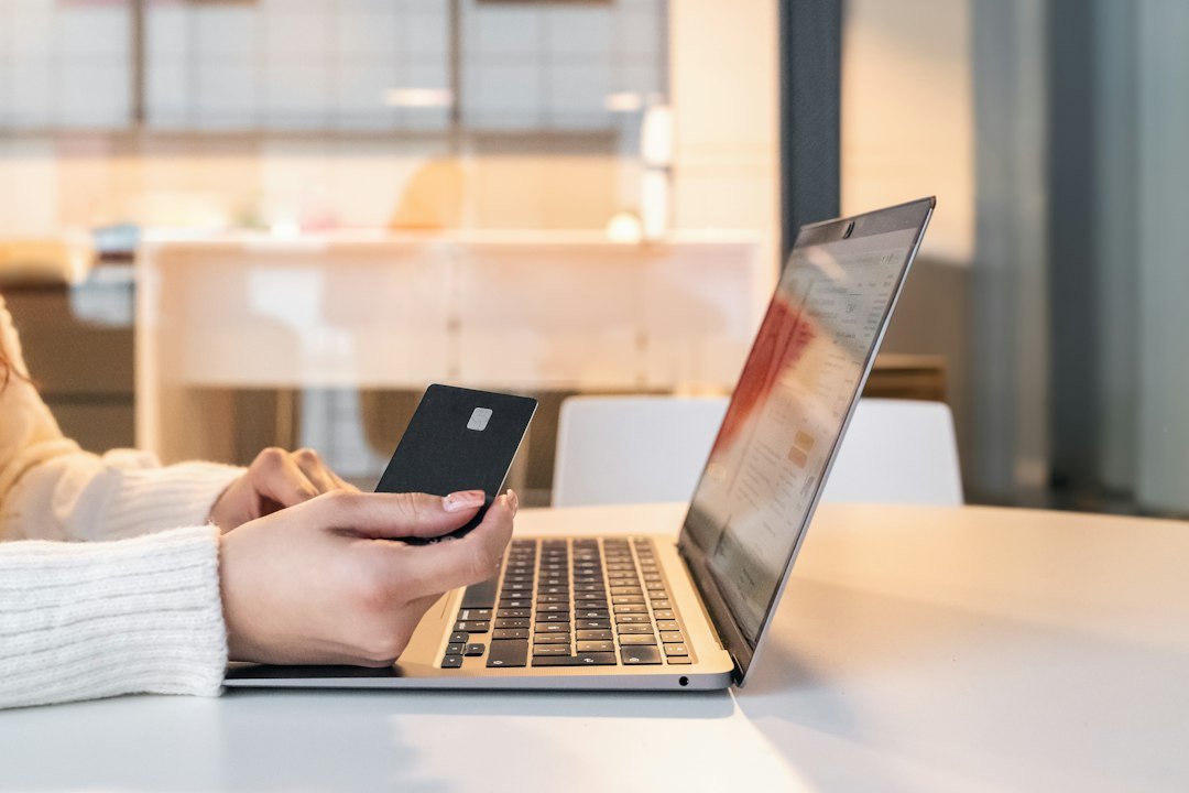 Laptop and payment card for checking subscription billing