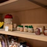 Small collectible figurines arranged on a shop display shelf