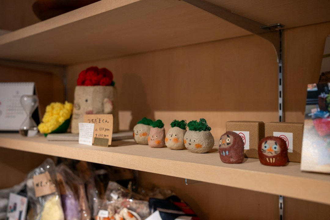 Small collectible figurines arranged on a shop display shelf