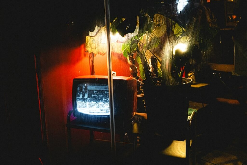 Television screen in a dim room illustrating Pluto TV playback troubleshooting