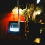 Television screen in a dim room illustrating Pluto TV playback troubleshooting